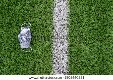 Green synthetic grass sports field with white line and mask. Soccer, rugby, football, baseball sport concept