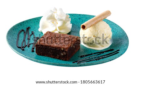 Sweet dessert, brownie with vanilla ice cream, cookie, syrup and cream