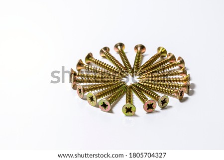 Gold screws are arranged in a circle on a white background. Yellow zinc head screws