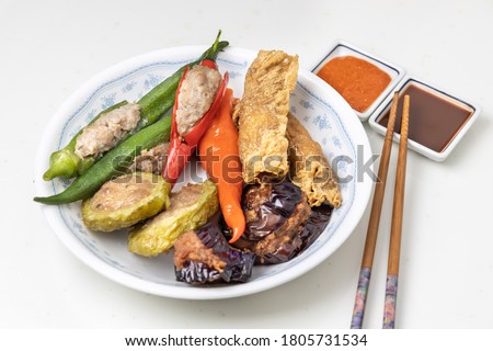 Variety of yong tau fu or stuffed tofu, popular Chinese food in Malaysia. Served with sauces. Royalty-Free Stock Photo #1805731534