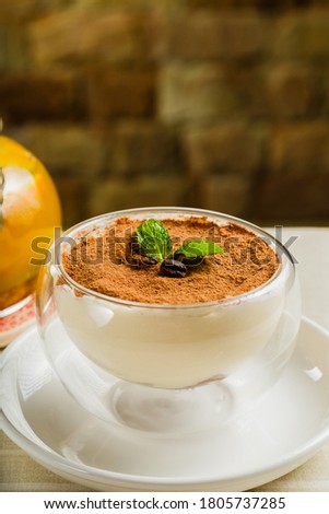 Fresh dessert with cocoa in a transparent bowl.