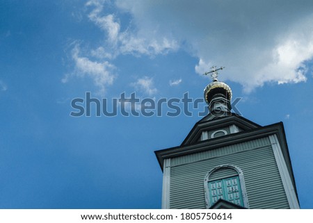 Classic orthodox church tower with golden cross on top