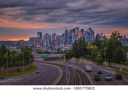 Cloudy sunrise sky over downtown Calgary roads