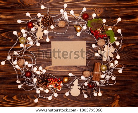 Christmas decorations and christmas lights on a wooden background. Postcard with wishes. Composition of festive elements. Christmas card and winter vacation. Happy New Year 2021. Xmas greeting card