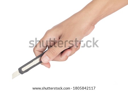 Hand holding Paper Cutter Knife isolated on a white background Royalty-Free Stock Photo #1805842117