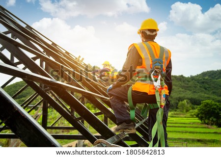 Asian worker wear safety height equipment to install the roof. Fall arrestor device for worker with hooks for safety body harness, Worker as in the construction site
 Royalty-Free Stock Photo #1805842813