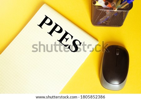computer mouse, pens, felt-tip pens, notepad with text Ppes on a yellow background