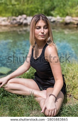 pretty woman doing yoga meditation near lake, outdoors. healthy lifestyle