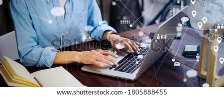 Close-up photo of female hands with laptop. Young woman working remotely at home. Concept of networking or remote work. Global business network. Online courses.
