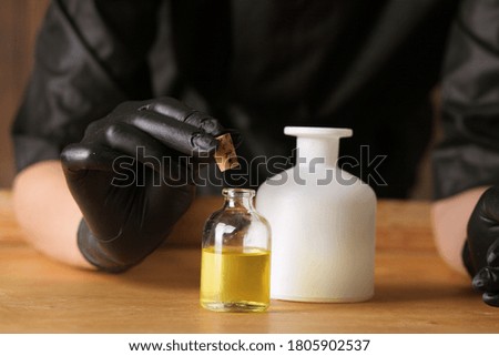 picture of female hands with oil bottle