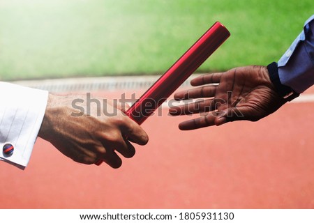 Businessmen passing baton. Conceptual image shot Royalty-Free Stock Photo #1805931130