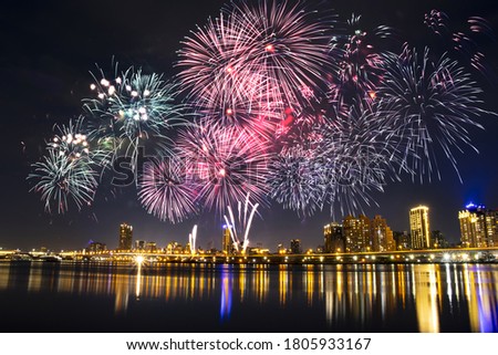 Fireworks on the riverbank at night