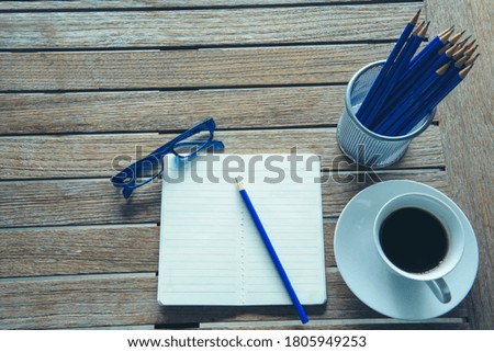 Office laptop business financial document chart and graph on wooden table with coffee cup. Flat lay notebook computer laptop on office desk. No people business graph chart mockup on business workspace