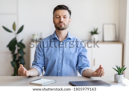Office Zen. Relaxed Male Entrepreneur Meditating At Workplace, Coping With Stress At Work, Sitting At Desk With Eyes Closed, Free Space Royalty-Free Stock Photo #1805979163