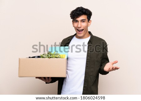 Young Argentinian man moving in new home over isolated background with shocked facial expression