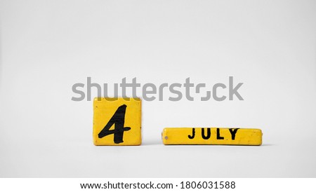JULY 4 Wooden calendar. Independence Day (United States). White background with space for your text                               