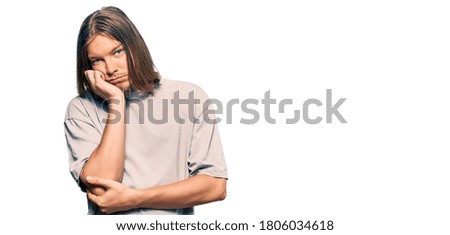 Handsome caucasian man with long hair wearing casual clothes thinking looking tired and bored with depression problems with crossed arms. 
