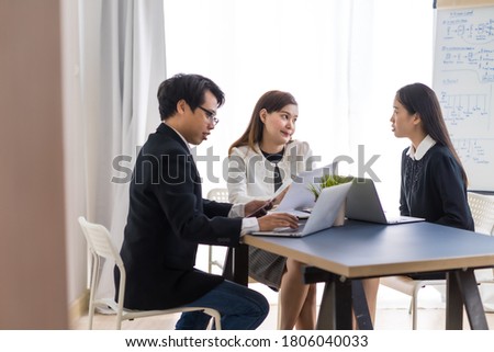 Group of business people busy discussing financial matter during meeting. Asian people