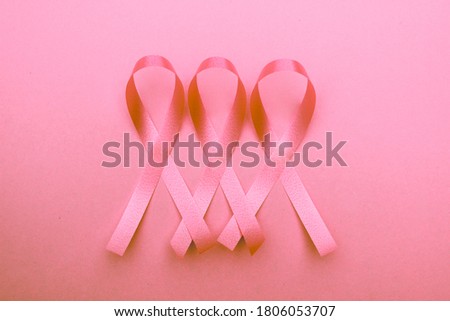 Ribbon on pink background  that show about  breast cancer awareness .On  picture can be use for text  and copy space.