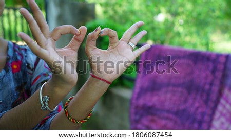 An adorable cute Indian girl show her hand, the sign hand language with blurred background. Expressing idea through fingers.