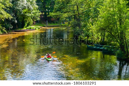 Holiday with canoes in the Krutynia river in Masuria land, Poland  Royalty-Free Stock Photo #1806103291