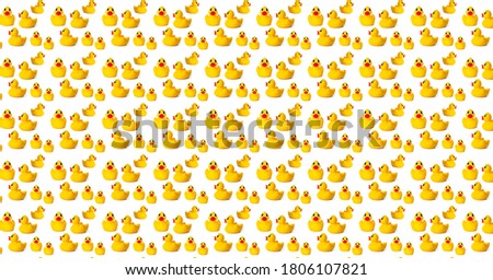 Pattern yellow rubber ducklings on a white background. Plastic baby toys for the bathroom.