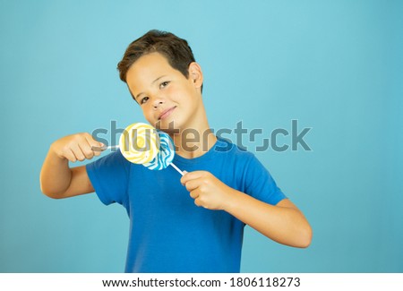 Smiling boy with lollipops in hand