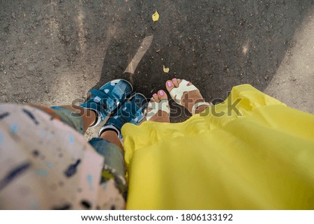 human feet in shoes on autumn ground
