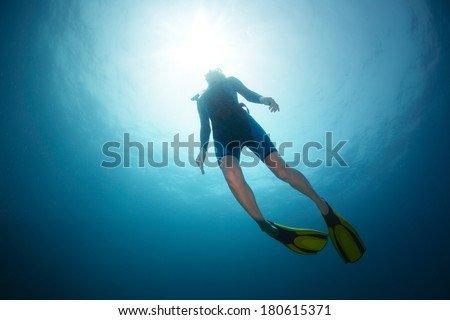 Free diver ascending to the surface Royalty-Free Stock Photo #180615371