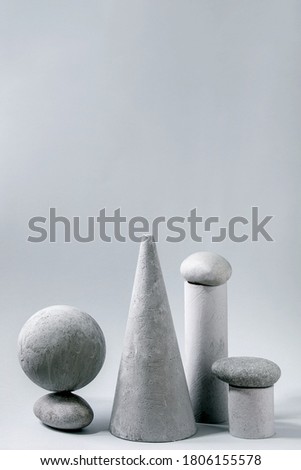 Abstract background with composition of different grey geometric objects and stones. Copy space. Modern concept for product presentation.