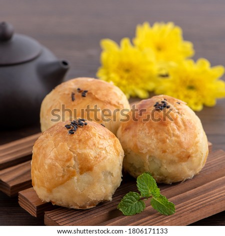 Moon cake yolk pastry, mooncake for Mid-Autumn Festival holiday, close up design concept on dark wooden table background