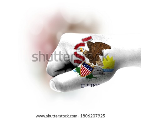 Flag of State of Illinois painted on male fist, strength,power,concept of conflict. On a blurred background.