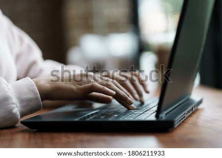 Close up of young female hands working on laptop. Business and finance stock photo