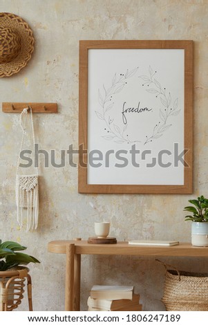 Bohemian interior of living room with mock up poster frame, elegant rattan accessories, plants, wooden console and hanging hut in stylish home decor.