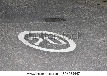 Twenty Mile Per Hour Speed Limit Sign in Road Paint on the Tarmac in a Residential Area in Edinburgh Scotland