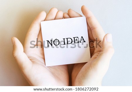 white paper with text No Idea in male hands on a white background