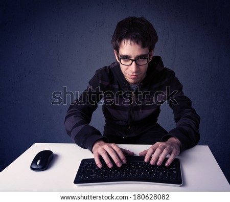 Hacker working with keyboard and mouse on blue background