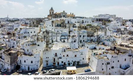 Aerial view of Ostuni "The White City" in Apulia, southern Italy - White houses in the old town built on a slope under the Romanesque cathedral