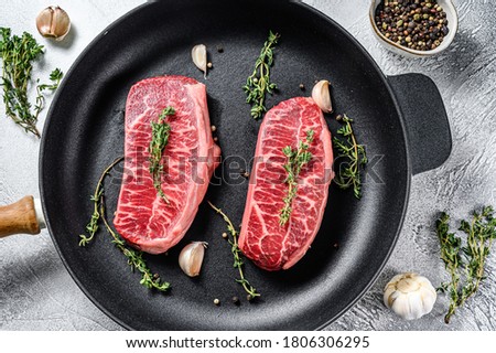 Raw marbled beef steak, top blade meat steak. Gray background. Top view Royalty-Free Stock Photo #1806306295