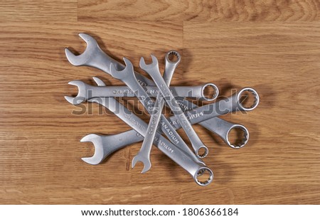 A set of metric spanners on a wooden table.