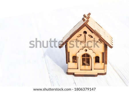 daylight. on a wooden background, toy house. Close-up.