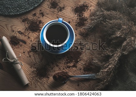 Cup filled with coffee on a woodden background