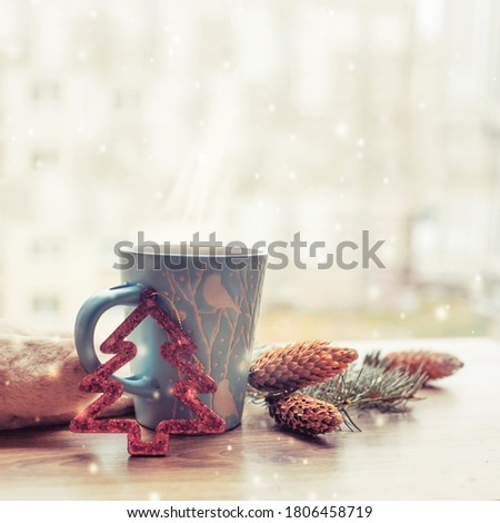 winter  christmas background with christmas tree decorations and cup of tea