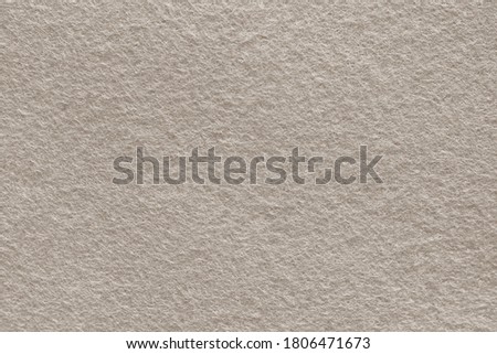 Gray brown felt background. Surface of fabric texture in  beige - brown color.