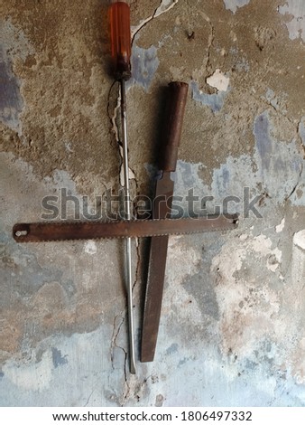Construction rusty tools hanging on wall background.Copy space for text