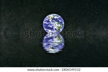 Beautiful unusual space planet in space reflected in water. Our beautiful Earth in reflection of water overlooking space ,galaxy stars night sky ,Elements of this Image Furnished by NASA ,