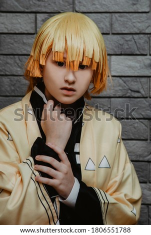 portrait of a teenage girl with yellow hair in an anime hero costume