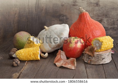 various and colorful autumnal vegetables and fruits on wooden background 