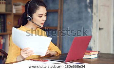 Working asian woman in the living room. Telemeeting. Video conference. Remote work. Royalty-Free Stock Photo #1806558634