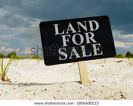 Land for sale. The sign is stuck in the ground.